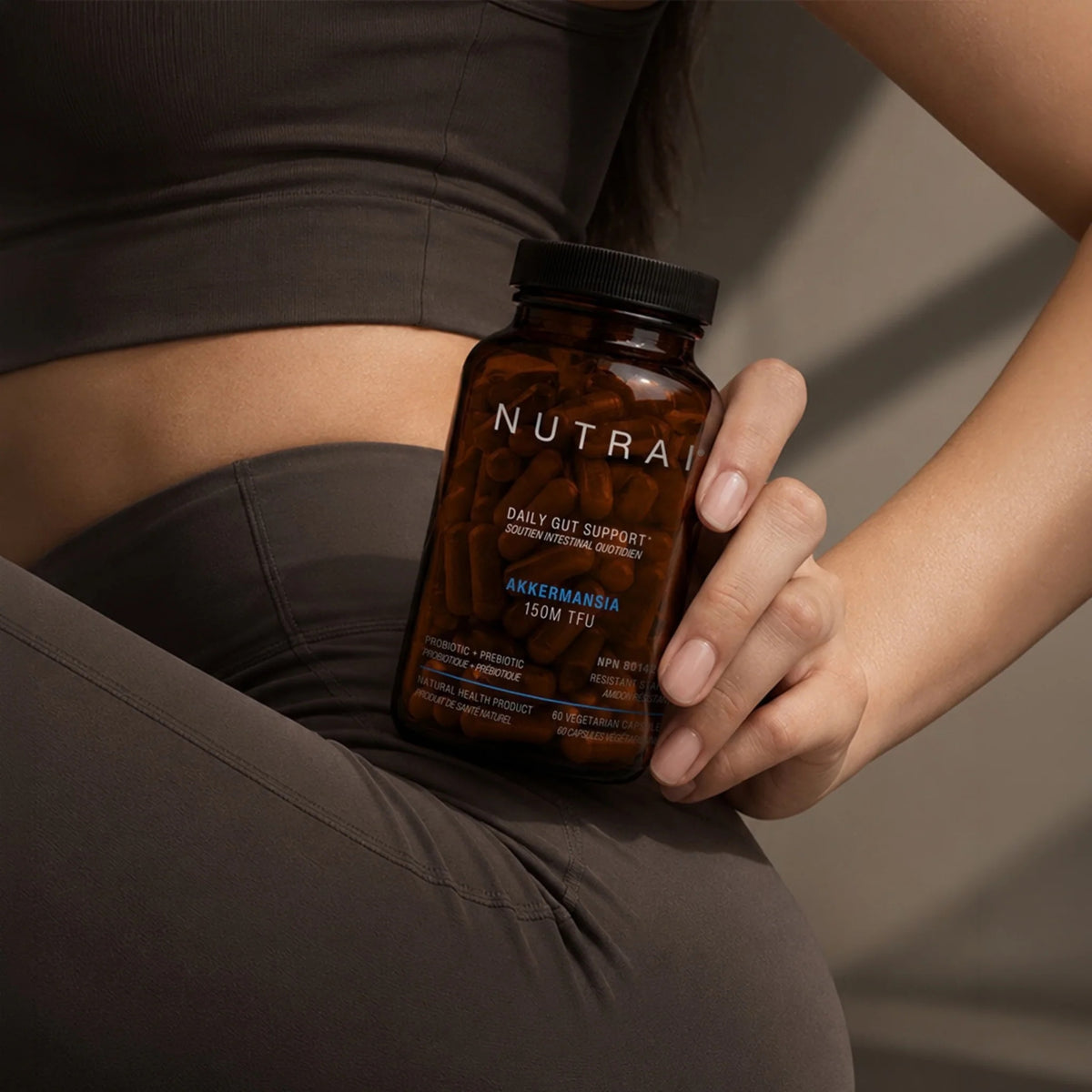 Holding a bottle of Nutrai Akkermansia